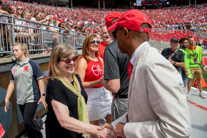 Marx-Scouras is congratulated by President Drake at the first football game of the season