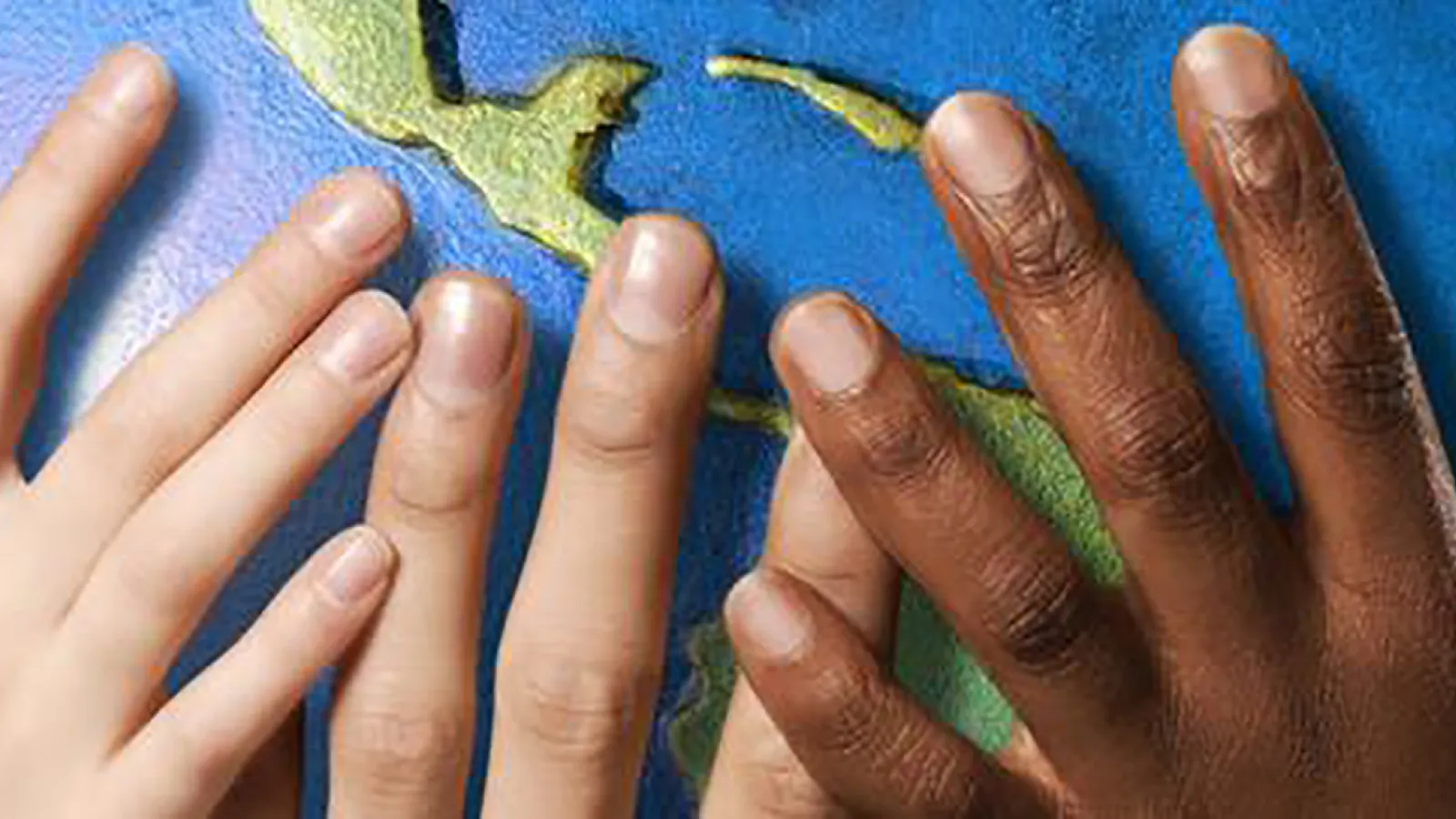 Diverse hands holding a globe
