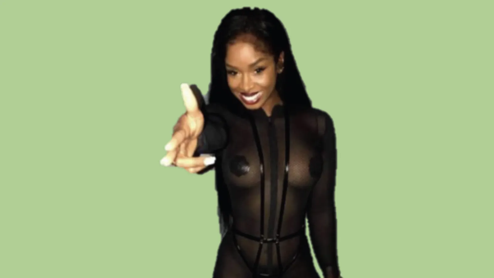 Woman wearing black outfit on light green background pointing