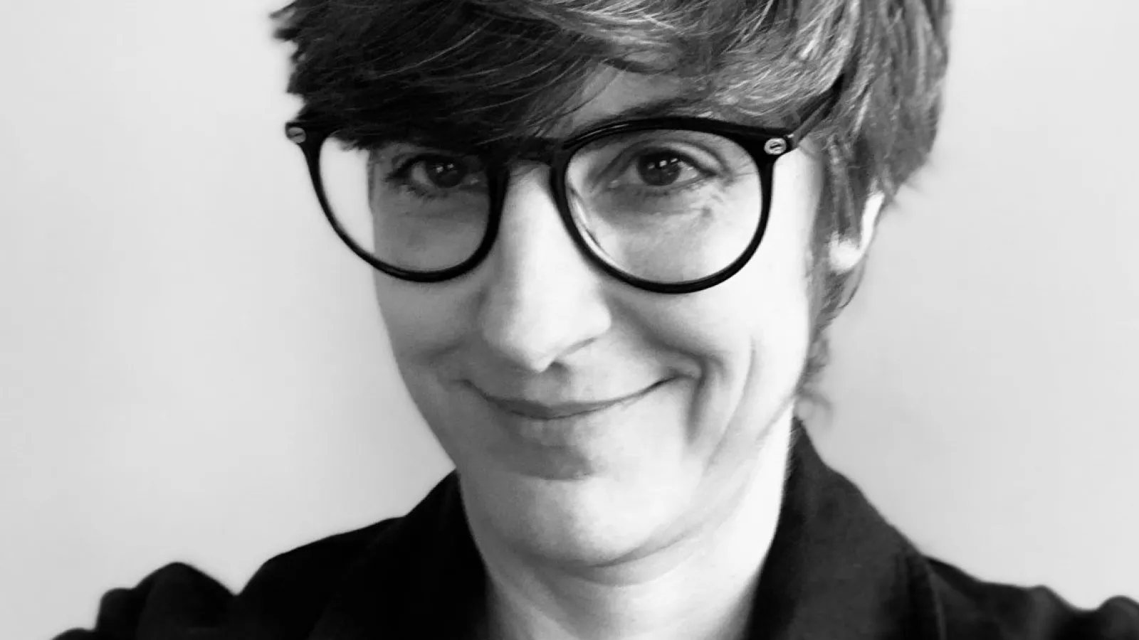 Woman with short hair and glasses
