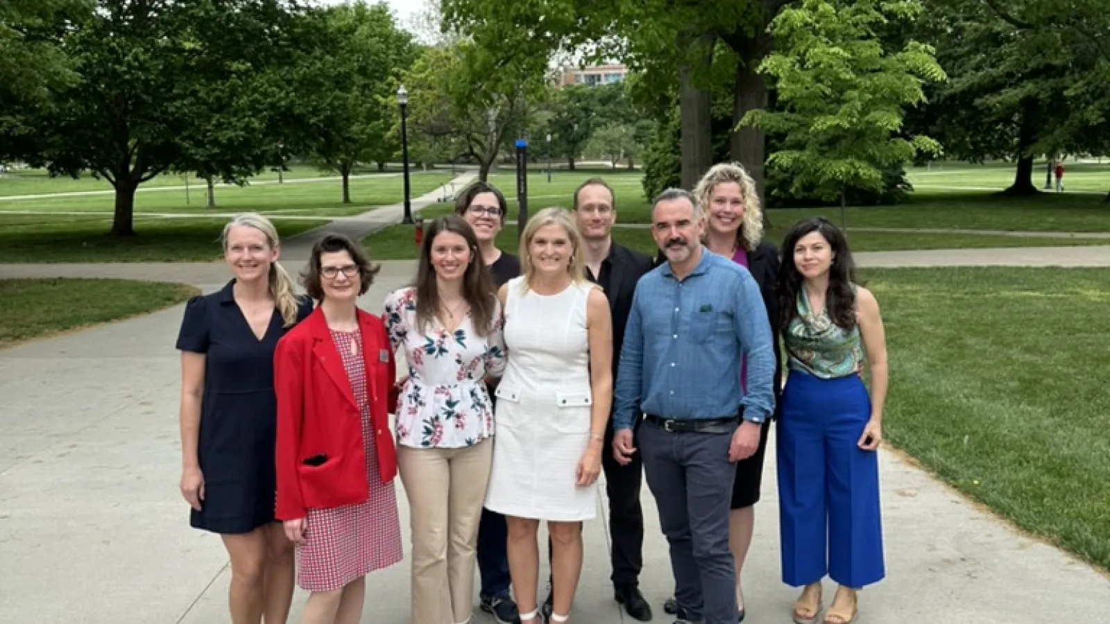 AY24 FRIT faculty at graduation reception with student speaker Julia 