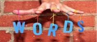 Hand holding the letters w o r d s