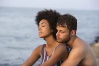 Two people cuddling on the beach