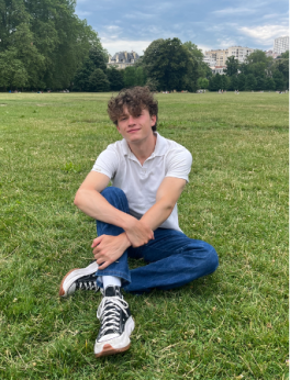 Man sitting in a grassy field.