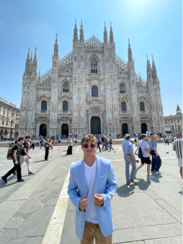 Man in front of a cathedral.