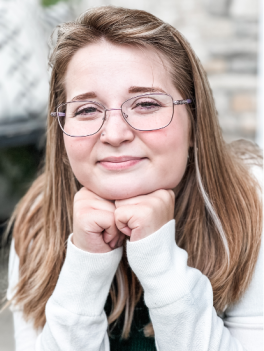 Blonde woman with glasses.