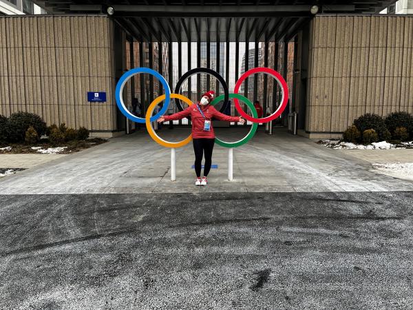 Andrea Braendli in front of Olympic rings in Beijing