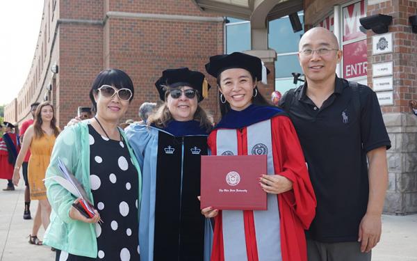 Graduate student and her family at graduation