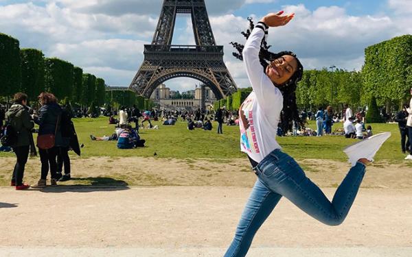 Student jumping in front of the Eiffel Tower
