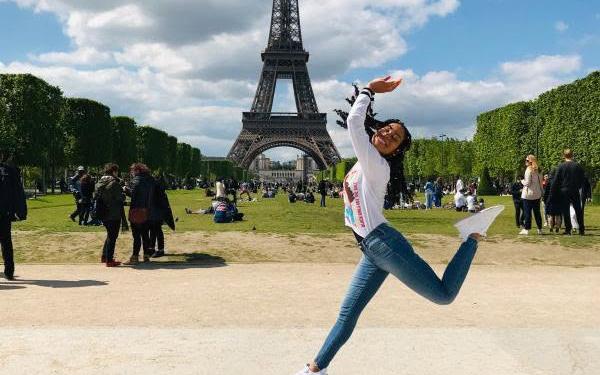 student jumping in front of Eiffel Tower 