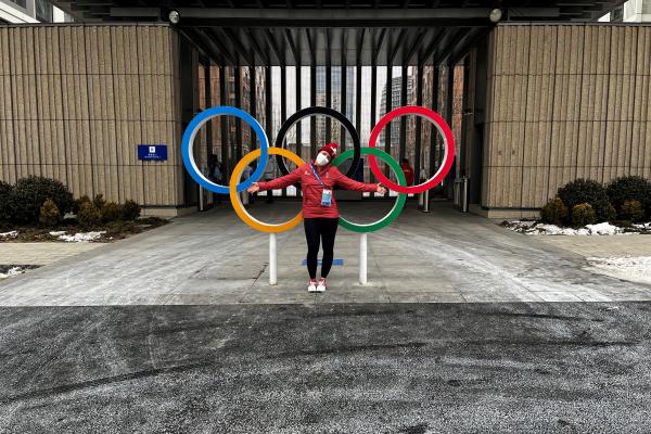 Andrea Braendli in front of Olympic rings in Beijing