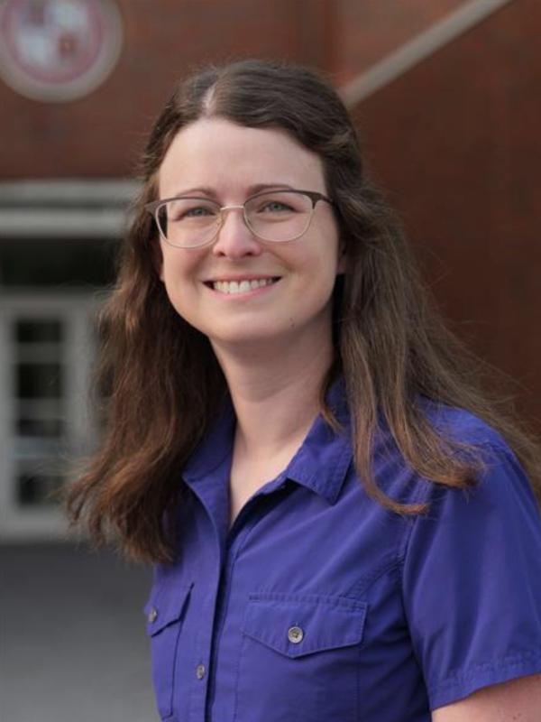 Jenna Thrash, Woman with brown hair, glasses, in a blue shirt 