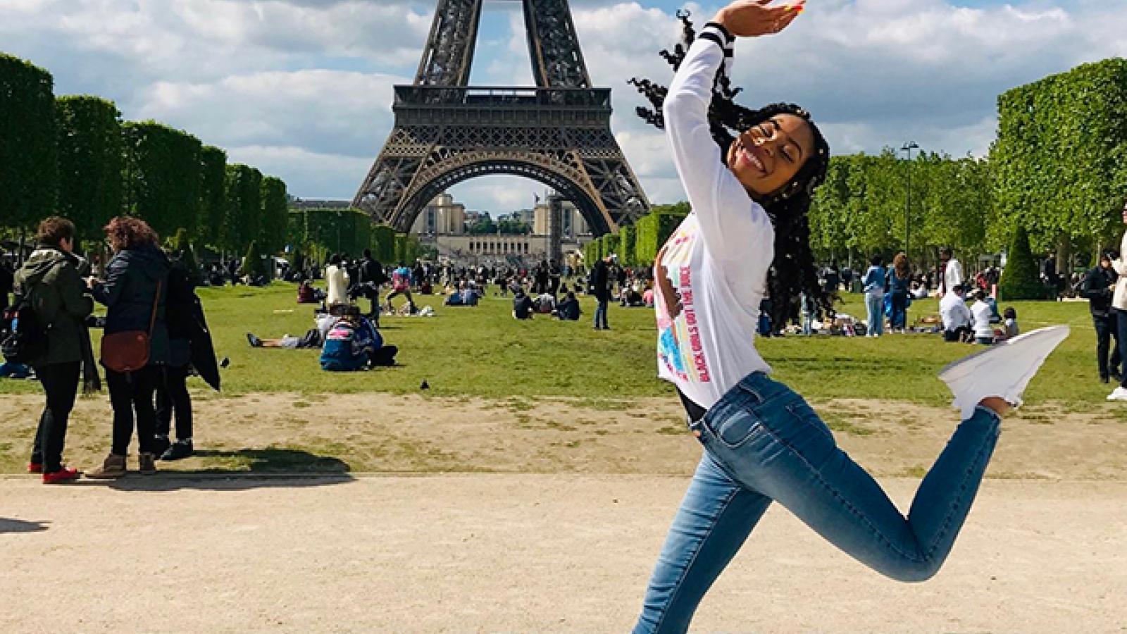 Student jumping in front of the Eiffel Tower