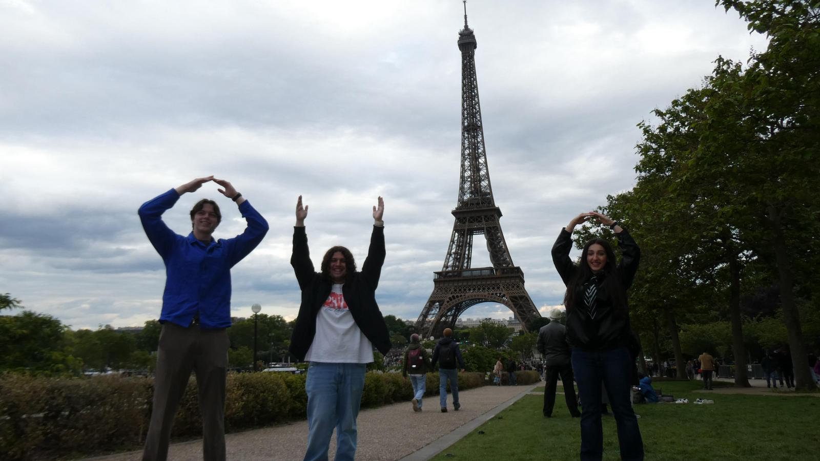 Students spelling O-H-I-O in front of the Eiffel Tower