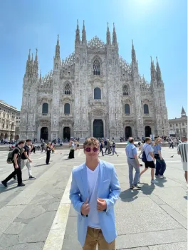Man in front of a cathedral.
